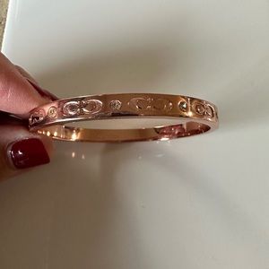 Rose colored Coach bracelet